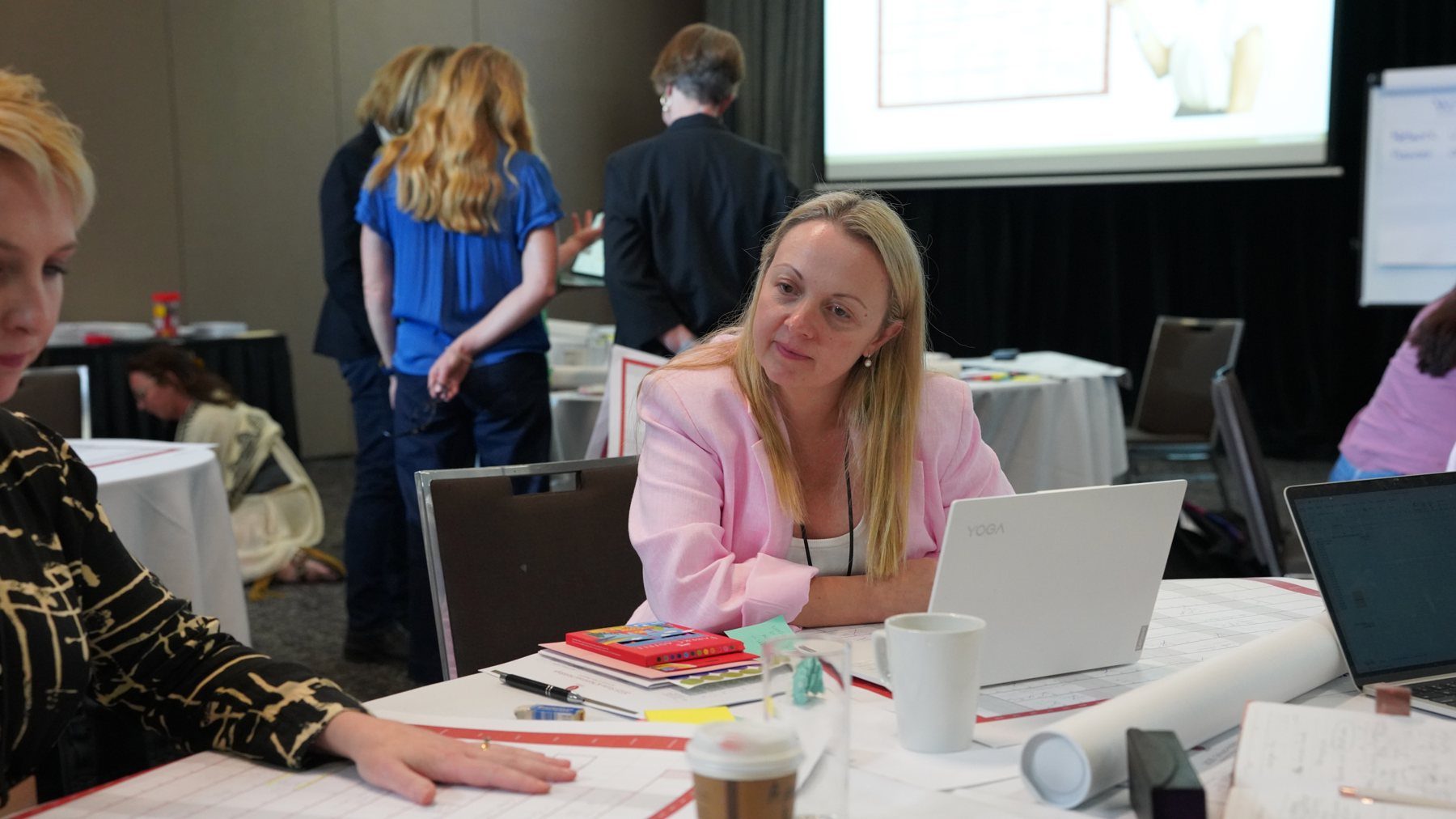 A HerBusiness member working through her plans on her laptop